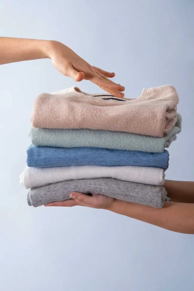 Neatly stacked clean clothes representing quality wash and fold service